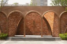 a brick wall with arches and steps leading up to it