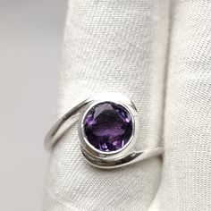 Natural Amethyst Ring, Faceted Round Shape Gemstone Ring, Handmade Amethyst Jewelry, 925 Sterling Silver Purple Cut Stone Ring  Material: Silver Gemstone: Amethyst Gem color: Purple  Stone Shape: Round Stone Type: Cut  Band color: Silver Ring Weight: 3.62gm ABOUT GEMSTONE:- Amethyst is linked to the element of wind.It is believed to prevent intoxication.This purple gemstone is associated with Royalty.This stone has amazing healing power and very helpful in purifying the mind and relieving stress Sterling Silver Amethyst Ring With Accent Stones, Amethyst Open Ring With Accent Stones, Silver Amethyst Gemstones In Round Cut, Sterling Silver Amethyst Birthstone Ring, Silver Amethyst Gemstones With Round Cut, Hallmarked Sterling Silver Purple Amethyst Ring, Hallmarked Purple Amethyst Sterling Silver Ring, Amethyst Ring With Round Stone, Purple Sterling Silver Ring With Round Stone