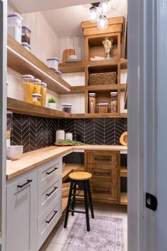 a kitchen with wooden shelves and white cabinets