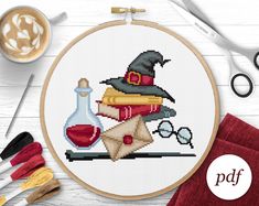 a cross stitch pattern with some sewing supplies