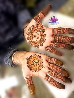 two hands with henna designs on them