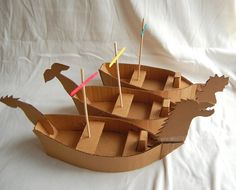 a cardboard boat made to look like an animal with wooden sticks sticking out of it