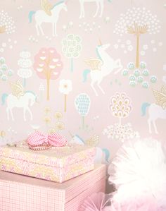 there is a pink and gold wallpaper with unicorns in the forest on it