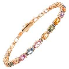 This Multi Sapphire Diamond Tennis Bracelet in 18K gold showcases endlessly sparkling natural multi sapphires of 8.09 carats and 0.2 carats of diamond. It measures 7 inches long in length. Sapphire stimulates concentration and reduces stress. Designed with perfect oval cut multi sapphire with diamonds in solid gold to make you stand out on any occasion or event. The elegant style complements the attire beautifully and is a perfect Engagement Gift, Bridal Shower Gift, Valentine Gift, Gift For Sis Colorful Tennis Bracelet, Perfect Engagement Gifts, Solid Gold Bracelet, Bracelet Tennis, Multi Sapphire, Diamond Tennis Bracelet, Gift Valentine, Bridal Shower Gift, Tennis Bracelet Diamond