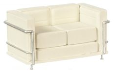 a white couch with metal arms on a white background