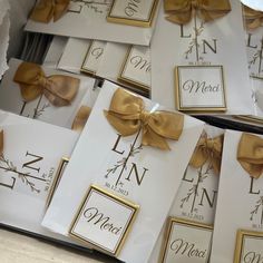 wedding cards with gold bows and monogrammed names