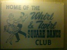 a sign that is on the side of a wall saying home of the mirror and two square dance club