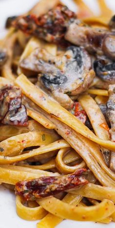 pasta with mushrooms and sauce on a white plate