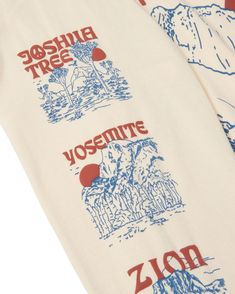 two white towels with red and blue designs on them, one has the word yosemite printed on it