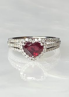 Heart Shaped Ruby Ring, Ruby Ring, Ruby Engagement Ring, Heart Ruby Ring, Ruby Ring For Women, Heart Ring, Heart Ring For Women, Luxury Gift This brand new 18k white gold ring is the ultimate symbol of love, featuring a high quality deep red heart shaped ruby weighing 1.15 carats surrounded by 0.43 carats of sparkling genuine white diamonds forming a perfect halo around the center stone and along the 3 row diamond encrusted band. *Approximate ring weight: 4.69 grams * Please note: This ring is p Kay Jewelers Engagement Rings, Dainty Earrings Studs, Engagement Ring Heart, Antique Emerald Ring, Vintage Sapphire Ring, Emerald Ring Vintage, Ruby Diamond Ring, September Birthstone Rings, Ruby Heart