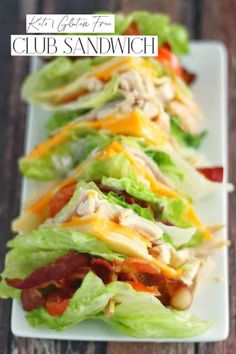 several lettuce wraps are lined up on a long white plate with cheese and bacon