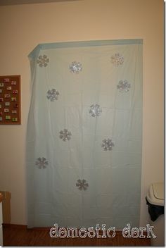 a bathroom with a white shower curtain next to a toilet