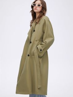 Details: Well-tuned trench coat in green khaki tone Waistband design allows for free waist cinching and a slight A-line hemline. The back panel is three-dimensional and strong, with a woven label design. Classic lapel Materials & Care: Cotton 55.6% Polyester 44.4%; Lining 1: Cotton 100%; Lining 2 Polyester 100% Hand wash | Dry clean Do not bleach Size & Fit: Model is 5'7", Bust 32, Waist 24, Hips 35, wearing a size S Item #: IN1OW03 Green Belted Long Coat, Green Outerwear With Belted Cuffs And Long Sleeves, Green Long Sleeve Outerwear With Belted Cuffs, Modern Green Outerwear For Fall, Spring Olive Single-breasted Outerwear, Modern Green Outerwear For Work, Khaki Spring Outerwear With Hidden Button Closure, Spring Khaki Gabardine Outerwear, Spring Khaki Outerwear With Hidden Button Closure