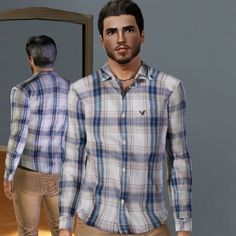 a man standing in front of a mirror wearing a plaid shirt and khaki pants