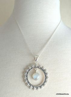 This beautiful floral solid sterling silver round pendant, with a dangling round labradorite or moonstone gemstone, is suspended on an 18 inch sterling silver 1mm cable chain. It is perfect for any occasion and is great for layering! Pendant height: 1.9 inches or 49mm, including bail Pendant width, at widest point: 1.5 inches or 38mm Dangling gemstone + silver setting diameter: 0.43 inches or 11mm Pendant setting and bail: sterling silver Convo me for a different length chain (additional charges Bohemian Round Moonstone Necklaces, Bohemian Moonstone Round Necklaces, Bohemian Moonstone Round Pendant Jewelry, Bohemian Jewelry With Round Pearl Pendant, Bohemian Style Jewelry With Round Pearl Pendant, Bohemian Style Round Pearl Pendant, Silver Moonstone Round Pendant Jewelry, Silver Moonstone Round Necklace, Bohemian Sterling Silver Round Necklace