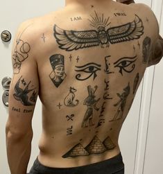 the back of a man with tattoos on his upper and lower body, including egyptian symbols