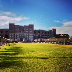 a large building sitting on top of a lush green field