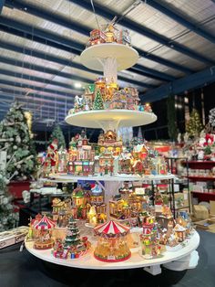 a christmas display in a store filled with lots of holiday decorations and lights on top of it