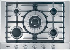 a stove top with four burners and three knobs on the front, in stainless steel