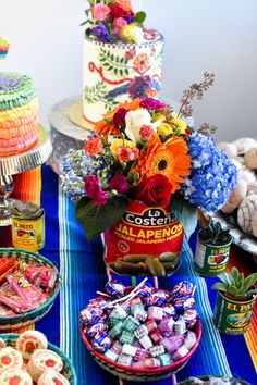 a table topped with lots of candy and cakes