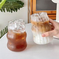 two iced drinks are sitting on a table