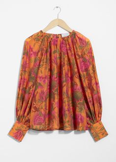 Long-sleeve blouse with a sheer finish. Featuring voluminous sleeves with fitted, buttoned cuffs.• Keyhole closure at the neck• Round neckline• Raglan sleeves• Length of blouse:60cm / 23.6" (Size S) Silk Blouses, Knit Outerwear, Orange Print, Women's Blouses, Skirt And Blouse, Women Shirts Blouse, Fashion Story, Linen Dresses, Swimwear Fashion