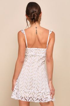 The Lulus Charmaine White Embroidered Mini Dress is sweet and simply divine! This femme little frock is formed from sheer mesh (atop a nude knit liner) embellished with ditsy floral embroidery. Ruffle trim accents the adjustable straps and tying keyhole neckline, while seamed cups meet with an empire waist. The figure flaunting silhouette ends at a ruffle-trimmed mini hem. Hidden back zipper/clasp. Fit: This garment fits true to size. Length: Above mid-thigh. Size medium measures 33" from top to Embroidered Mini Dress, Adhesive Bra, Keyhole Neckline, Ditsy Floral, Ruffle Trim, Empire Waist, Floral Embroidery, Adjustable Straps, Size Medium