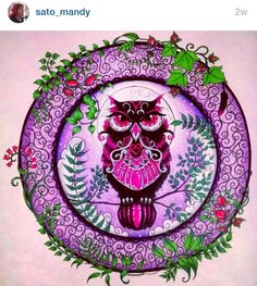 an owl sitting on top of a purple plate with green leaves around it's edges