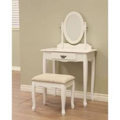 a white dressing table with a stool and mirror