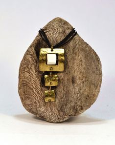 This pendant is dedicated to the Nine Muses: Urania.  It is made from brass.  It is decorated with white coral natural flakes.  It is hand sawed, texturized and cold forged.  The result is a unique leather-like texture that reflects light like velvet. Handmade Rectangular Brass Necklace, Handmade Bronze Necklace With Rectangular Pendant, Bronze Handmade Necklace With Rectangular Pendant, Handmade Brass Necklace With Square Pendant, Handmade Artistic Necklace With Rectangular Shape, Handmade White Brass Necklaces, Handmade White Brass Necklace, The Nine Muses, White Coral