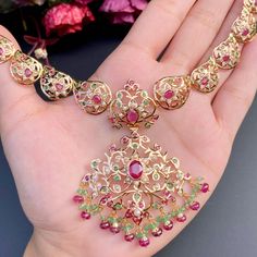 Featuring an elegant rajasthani necklace set crafted in 22ct gold and embellished with precious pearls, rubies and emeralds. The necklace weighs 27.16 GMs including 1.77 GMs of hanging ruby emerald beads and the earrings weigh 17.10 GMs including 2.82 GMs in hanging ruby emerald beads. This unique set is sure to make a dazzling statement. Each piece is carefully crafted with attention to detail, making this set an heirloom-quality item. Price Breakup Summary Component Rupees % of Total 22k Gold Rajasthani Necklace, Jadau Necklace Set, 22k Gold Jewelry Necklaces, 22k Gold Jewelry, Pearl Necklace Set, 22 Carat Gold, Emerald Bead, Ruby Emerald, Gold Jewelry Necklace