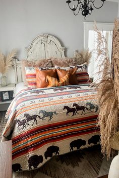 a bedroom with a bed, pillows and rugs