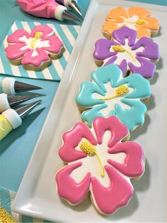 decorated cookies on a plate with markers and pens