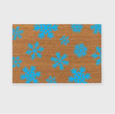 a blue and brown rug with snowflakes on it