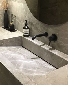 a bathroom sink with two faucets and soap dispenser