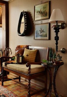 a living room filled with furniture and pictures hanging on the wall above it's doorway