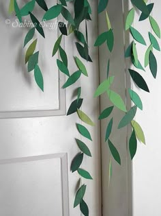 some green leaves hanging from the side of a door