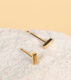 The earring equivalent of the perfect denim jeans, once you own the Mini Gold Bar Earrings you'll wonder how you lived without them. Small but perfectly formed in gold, they add instant good vibes to days in and nights out.Length: .5cmWidth: .15cmThickness: .13cmSpecs Description: A pair of geometric gold bars sit on gold posts, secured by wing nut closures. Gold Bar Earrings Studs, Bar Earring, Earring Minimalist, Minimalist Bar, Gold Bar Earrings, Mini Gold, Geometric Studs, Bar Stud Earrings, Bar Studs