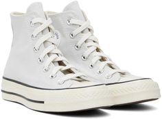 Converse.Gray Chuck 70 Vintage Canvas Sneakers.High-top 12 oz canvas sneakers in gray..· Rubber cap toe.· Lace-up closure.· Logo patch at inner side.· Eyelets at inner side.· Cushioned OrthoLite® footbed.· Rubberized logo patch at heel.· Treaded rubber sole.· Contrast stitching in white.Supplier color: Fossilized/Egret/Black.Upper: textile. Sole: rubber..Made in Viet Nam..241799F127080 White Lace-up Sneakers With Canvas Lining, Gray High-top Canvas Shoes With Vulcanized Sole, Gray High-top Canvas Shoes, White Sneakers With Canvas Lining For Streetwear, White Canvas Lined Sneakers For Streetwear, Lace-up High-top Cotton Sneakers With Rubber Toe Cap, Casual White Canvas Shoes With Canvas Lining, Cotton Lace-up High-top Sneakers With Rubber Toe Cap, Converse High-top Sneakers With White Laces For Streetwear