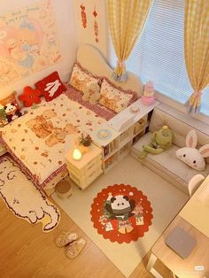 a small child's room with a bed, desk and stuffed animals on the floor