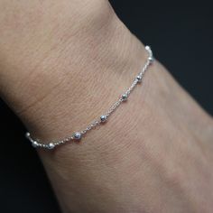 The elegant ball chain bracelet is crafted from fine sterling silver, featuring uniformly sized beads for a refined appearance. Its simple yet sophisticated design makes it perfect for both casual and formal occasions. The bracelet is finished with a secure lobster clasp for added durability. * Design: Anchor Bracelet * Material: High-quality 925 sterling silver for lasting shine. * Tarnish resistant + Hypoallergenic * Bracelet length: 16.5 cm+3.5 cm  * Chain thick: 1.2 mm, ball thick: 2mm * Com Minimalist Ball Chain Bracelets As Gift, Elegant Silver Bracelet With Ball Chain, Elegant Silver Ball Chain Bracelet, Minimalist Beaded Bracelets With Ball Chain, Silver Dainty Beaded Bracelets, Silver Ball Chain Bracelet, Sterling Silver Satellite Chain Bracelet For Everyday, Silver Beaded Chain Bracelet As Gift, Everyday Sterling Silver Chain Bracelet With Satellite Chain