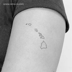 a woman's arm with a small map tattoo on the back of her thigh