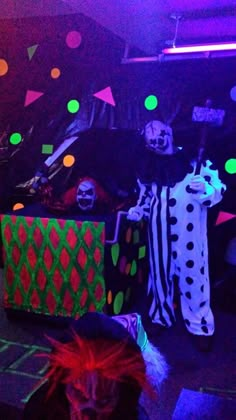 a group of people dressed up as clowns in a dark room with neon lights