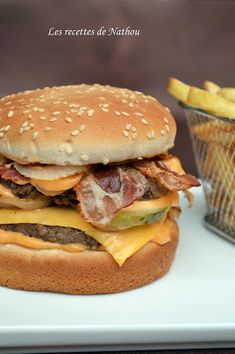 a bacon cheeseburger with fries on the side