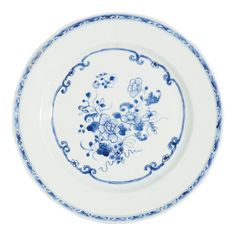 a blue and white plate with flowers in the center on a white background is shown