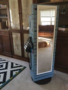 a room with a mirror on the floor and a dog laying down in the background