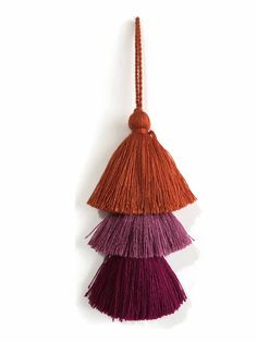 three tassels hanging on a white wall