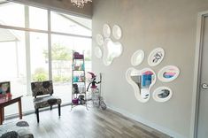 a living room filled with lots of furniture next to a large glass wall covered in animal paw prints