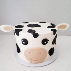 a close up of a cake with a cow face on it