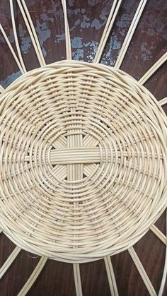 a wicker chair sitting on top of a wooden table